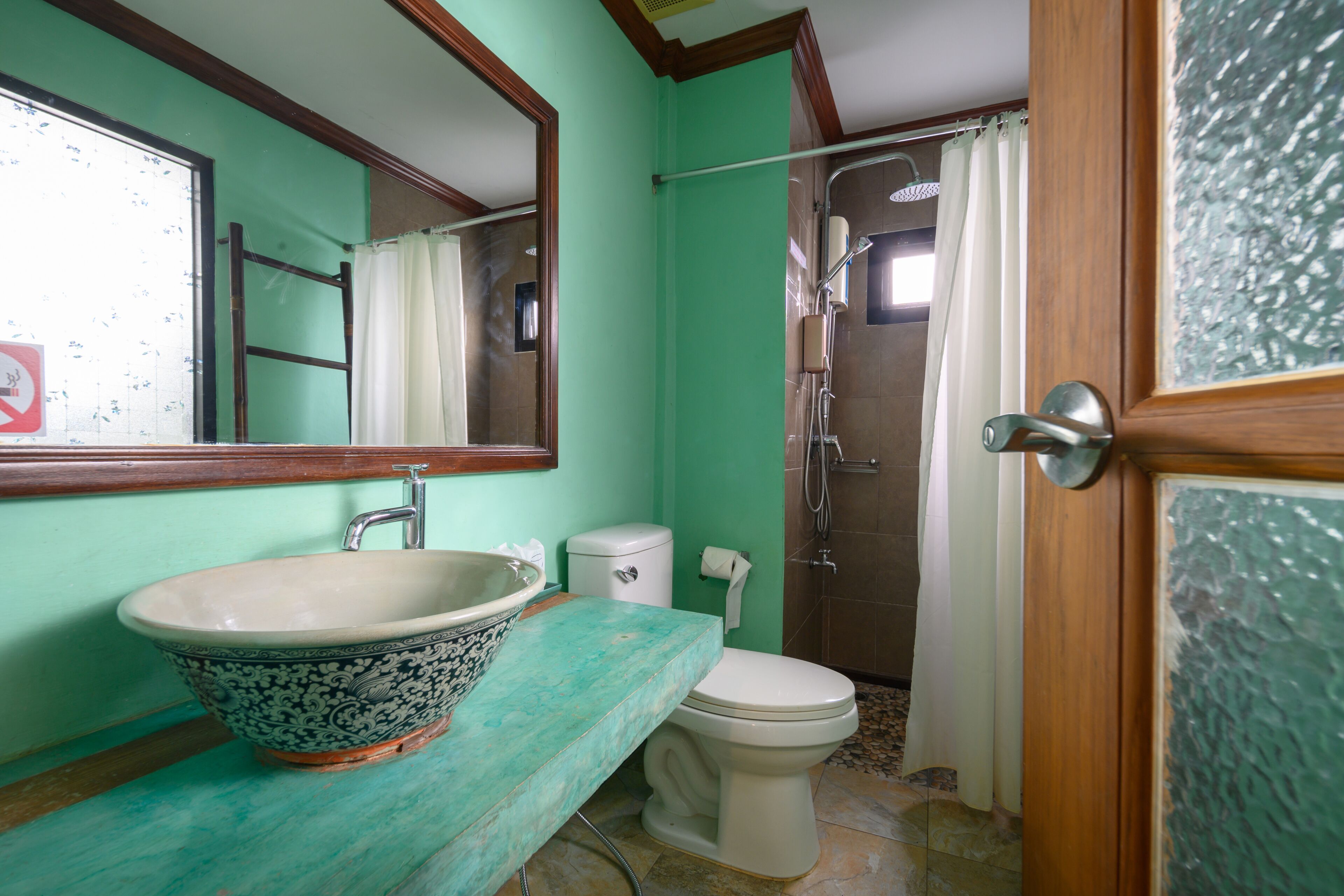 A bathroom with a sink, toilet, and shower.