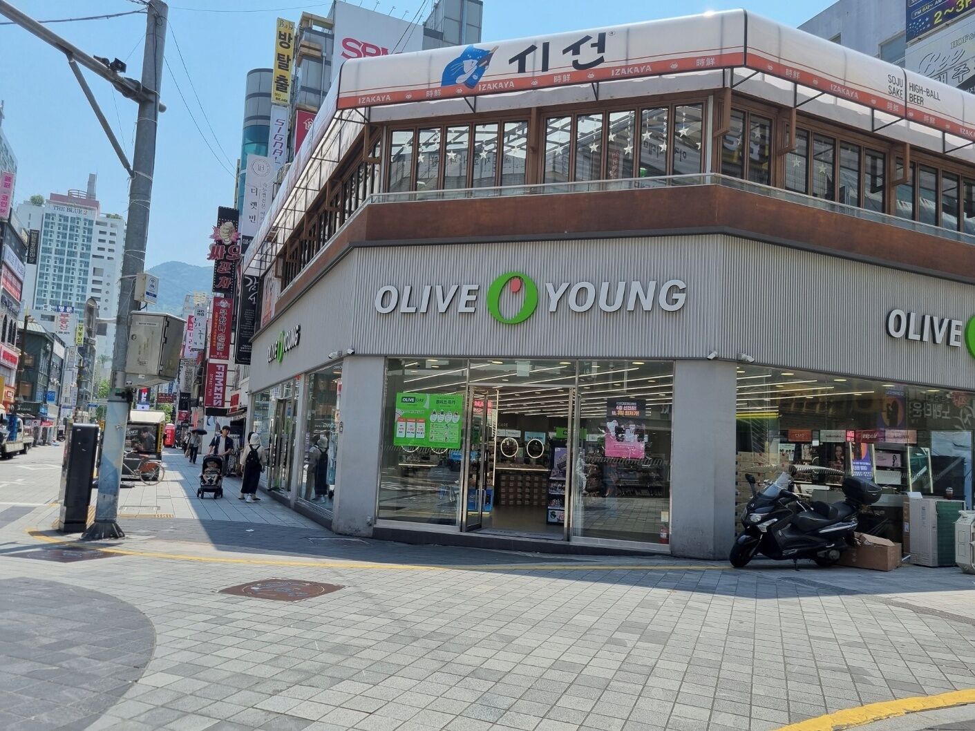 A storefront with the sign "OLIVE YOUNG" and a green logo.