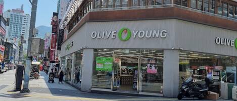 A storefront with the sign "OLIVE YOUNG" and a green logo.