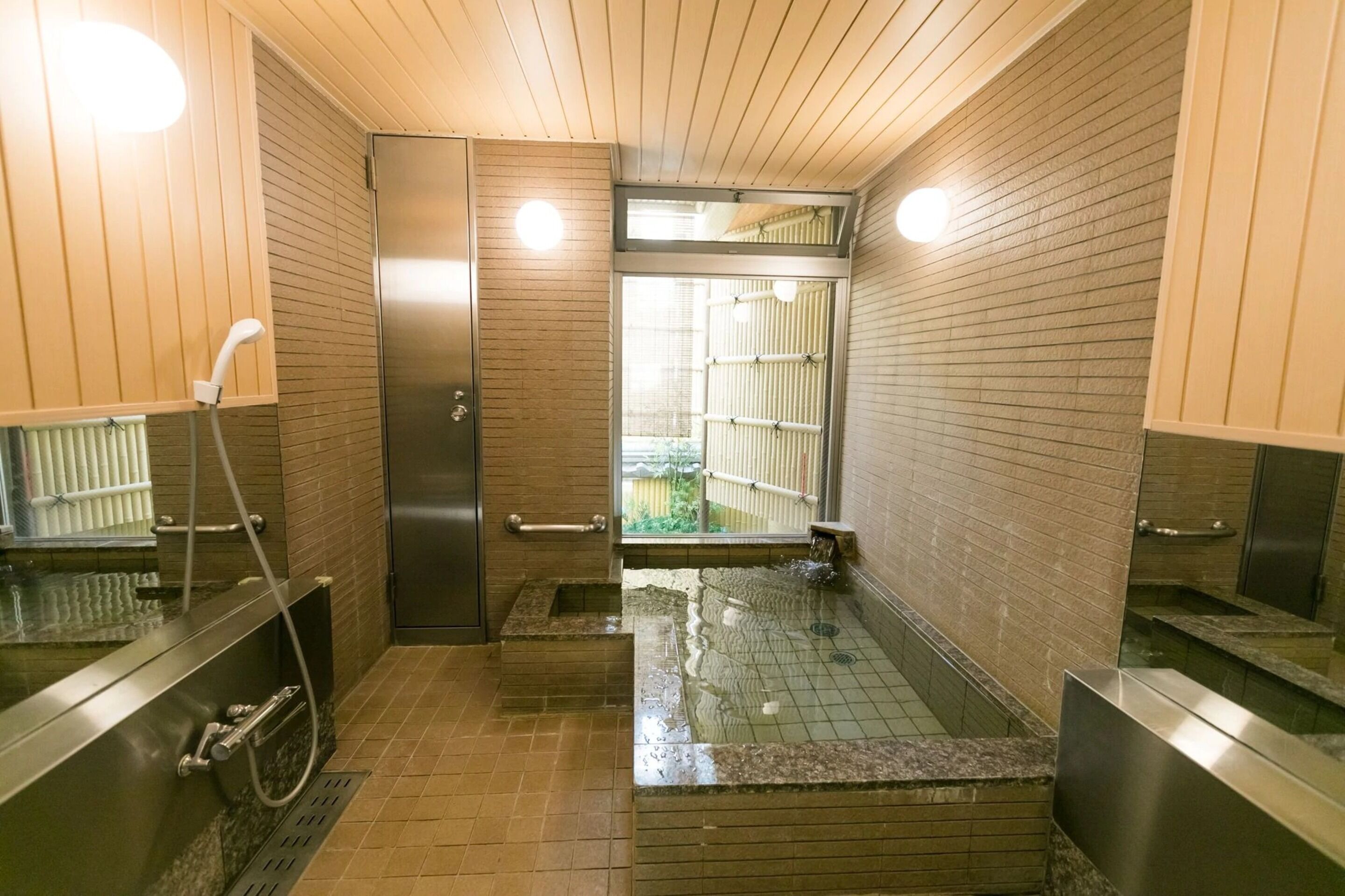 A modern bathroom with a glass-enclosed shower, a towel rack, and a toilet.