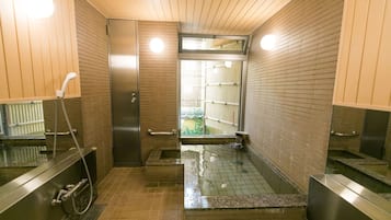 A modern bathroom with a glass-enclosed shower, a towel rack, and a toilet.