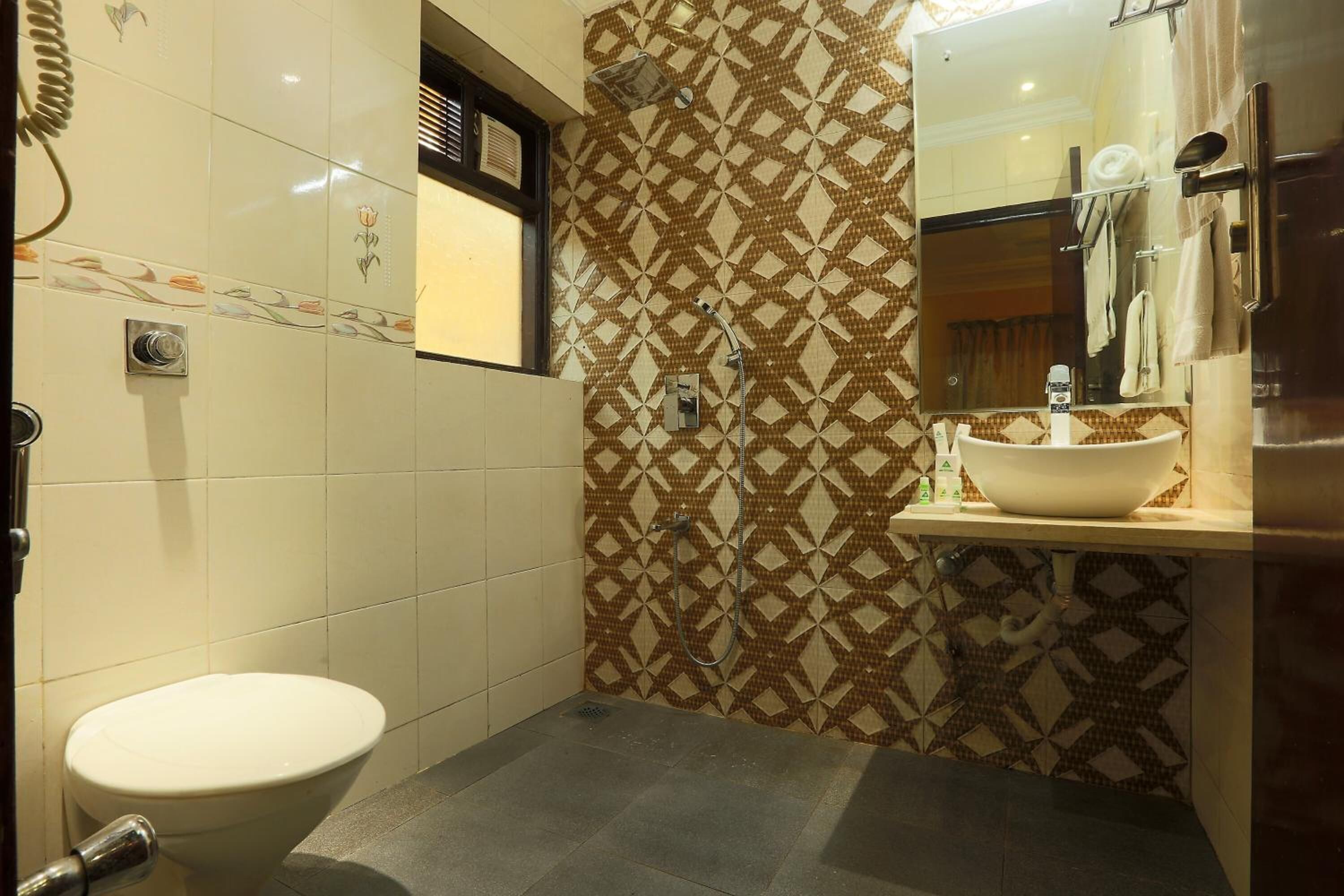 A bathroom with a toilet, a sink, and a shower.