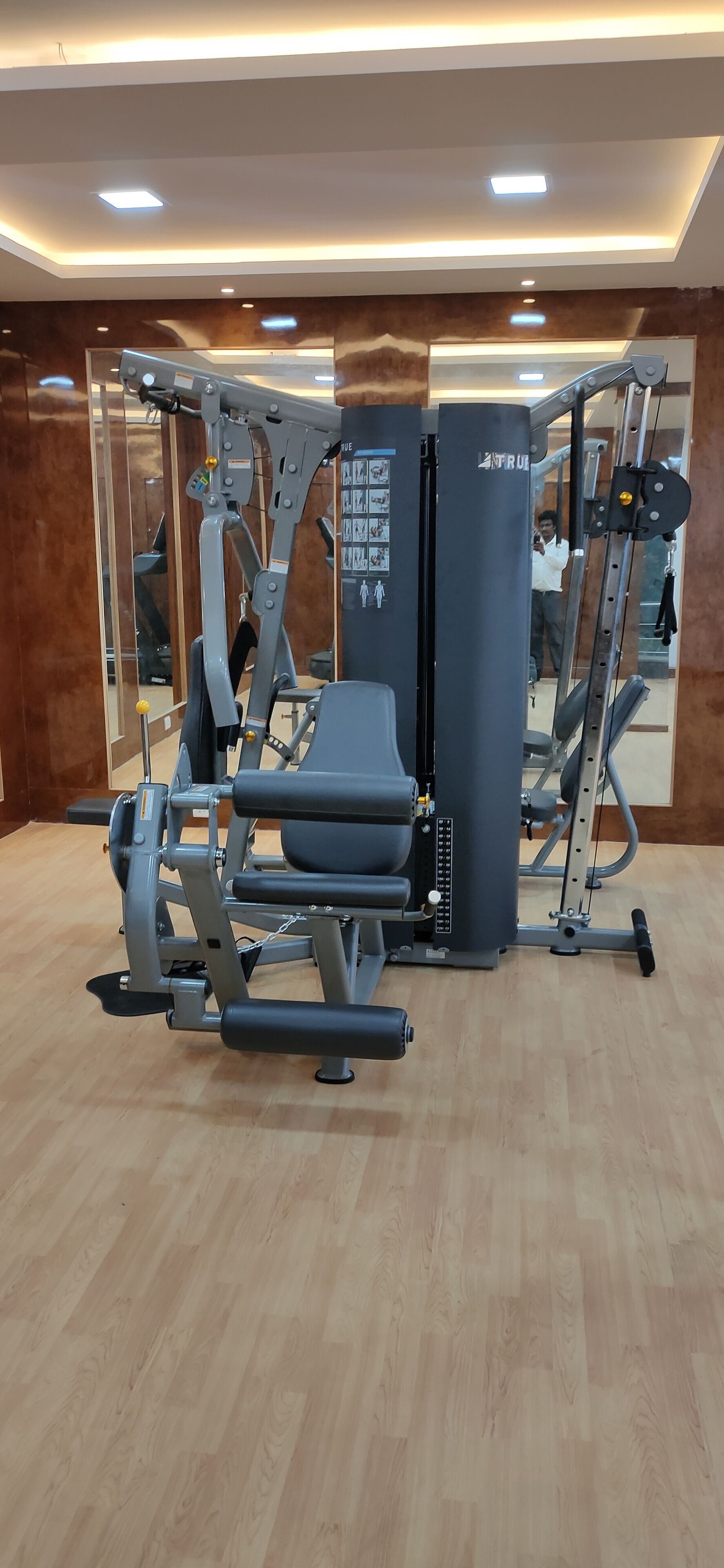 A gym with a weight bench, a squat rack, and a bench press.