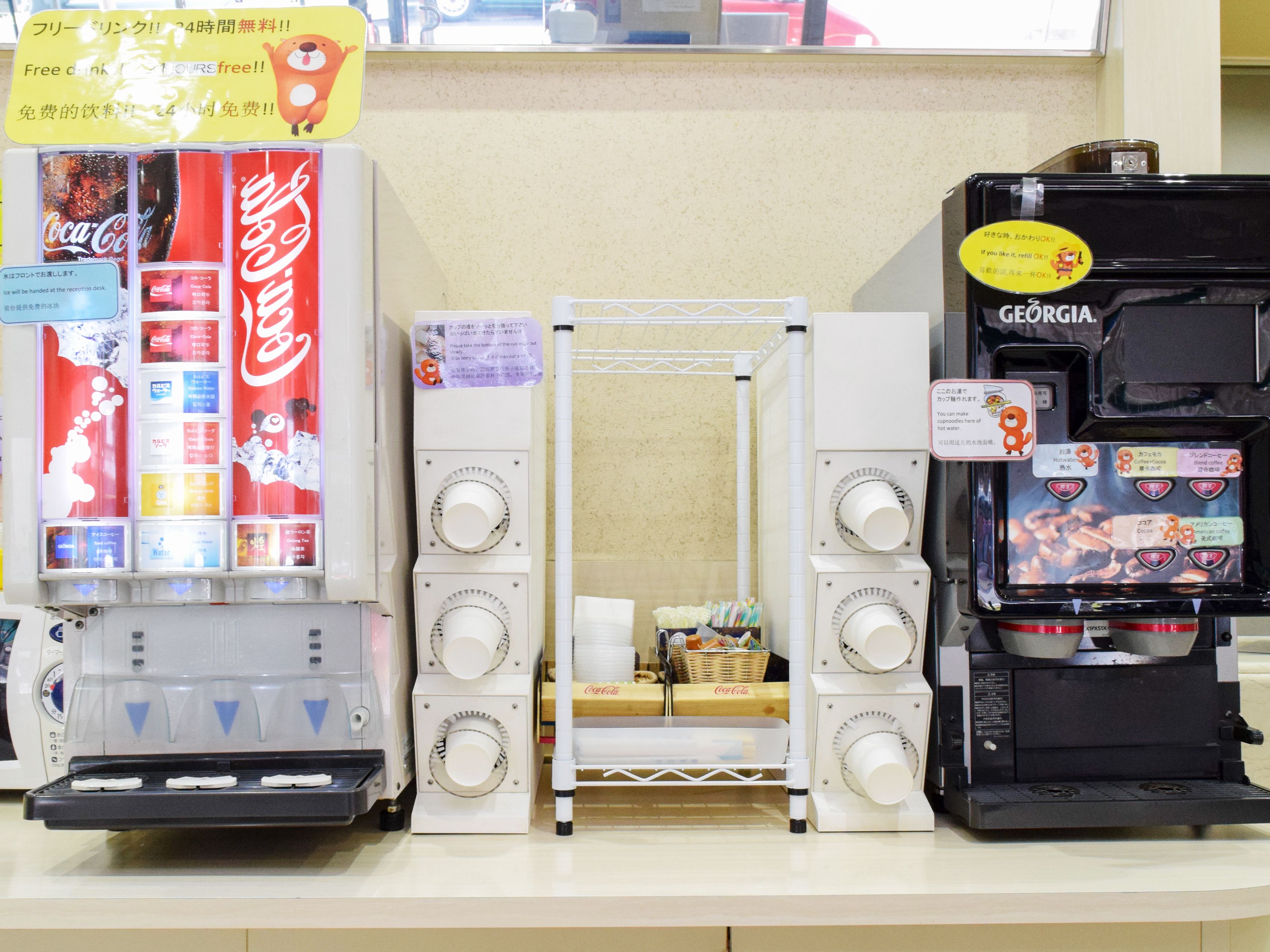 A coffee machine with a GEORGIA logo and a Coca-Cola branded dispenser.