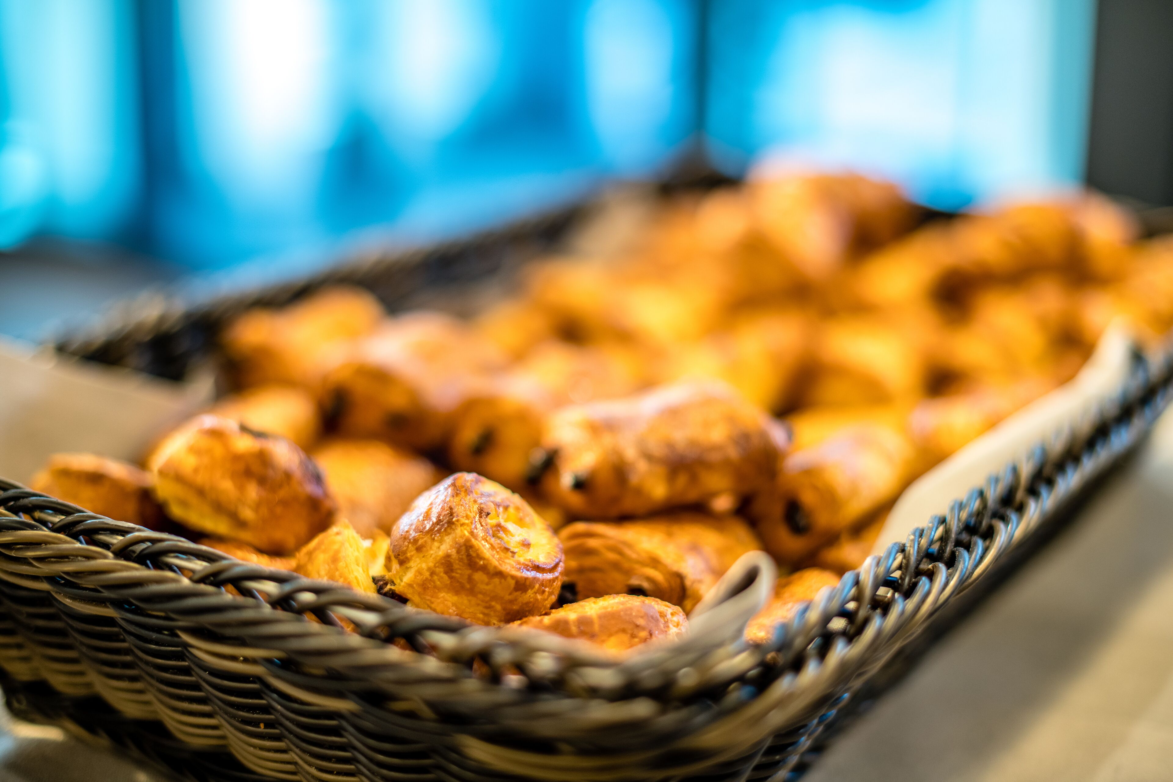 A wicker basket filled with golden-brown pastries.