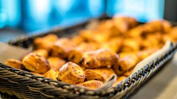 A wicker basket filled with golden-brown pastries.