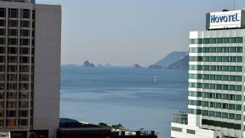 A hotel with a view of the sea and distant islands.