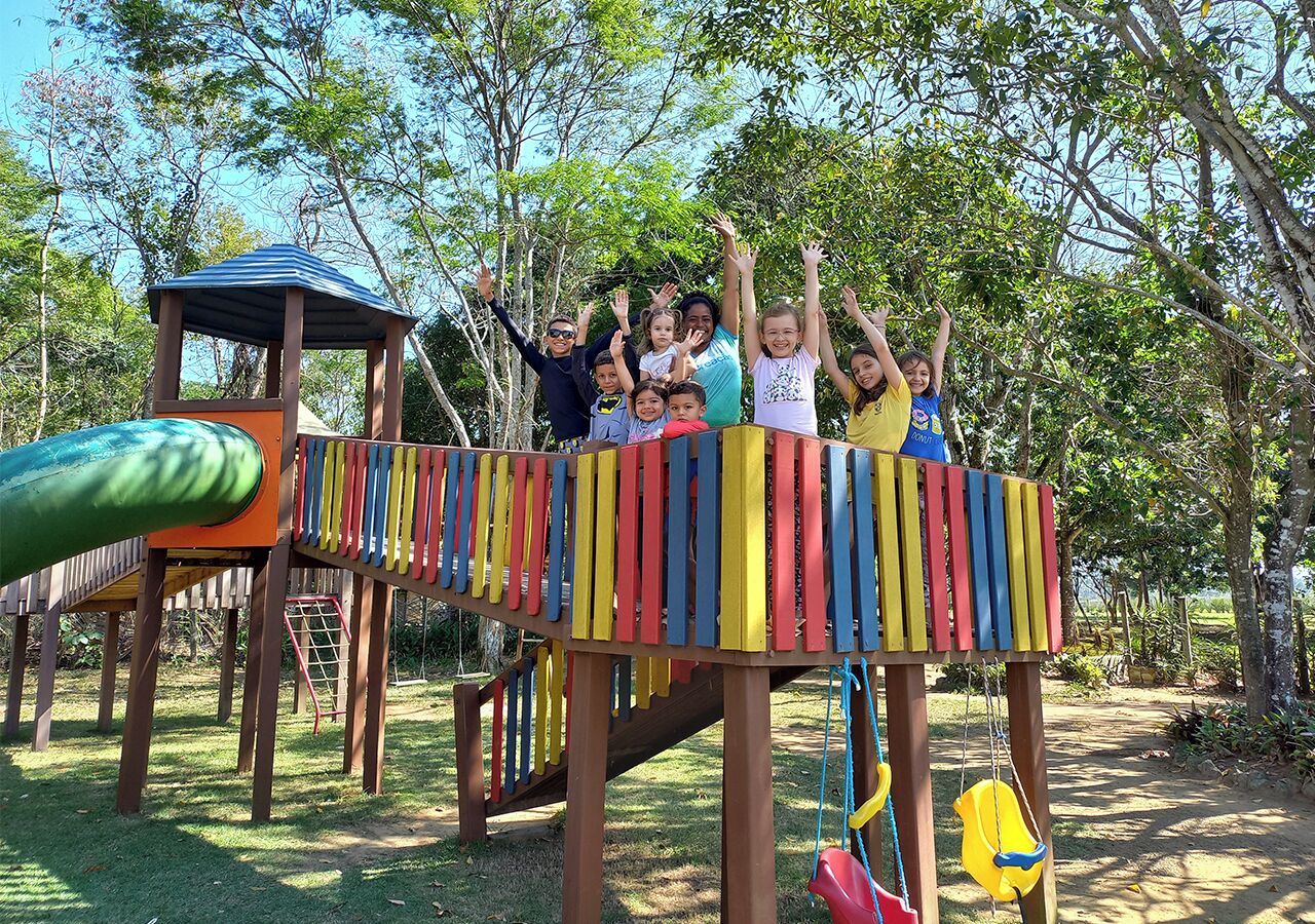 A playground with a colorful play structure and a slide.