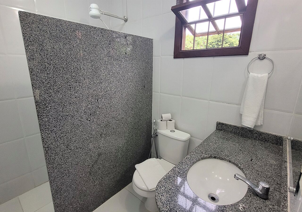 A bathroom with a shower, toilet, and sink.