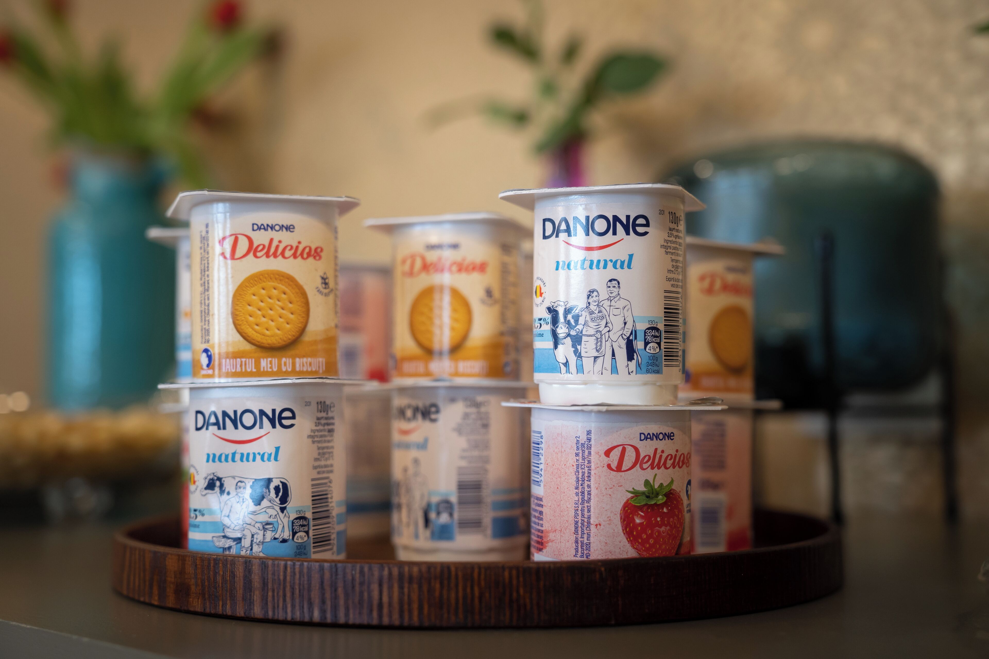 A tray with several Danone Delicios yogurt containers.