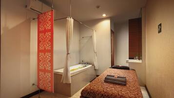 Relax in a serene space with a large bed and spa-inspired bathroom.