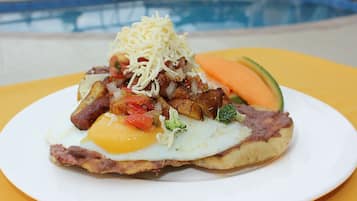 A plate of food with eggs, cheese, and vegetables.