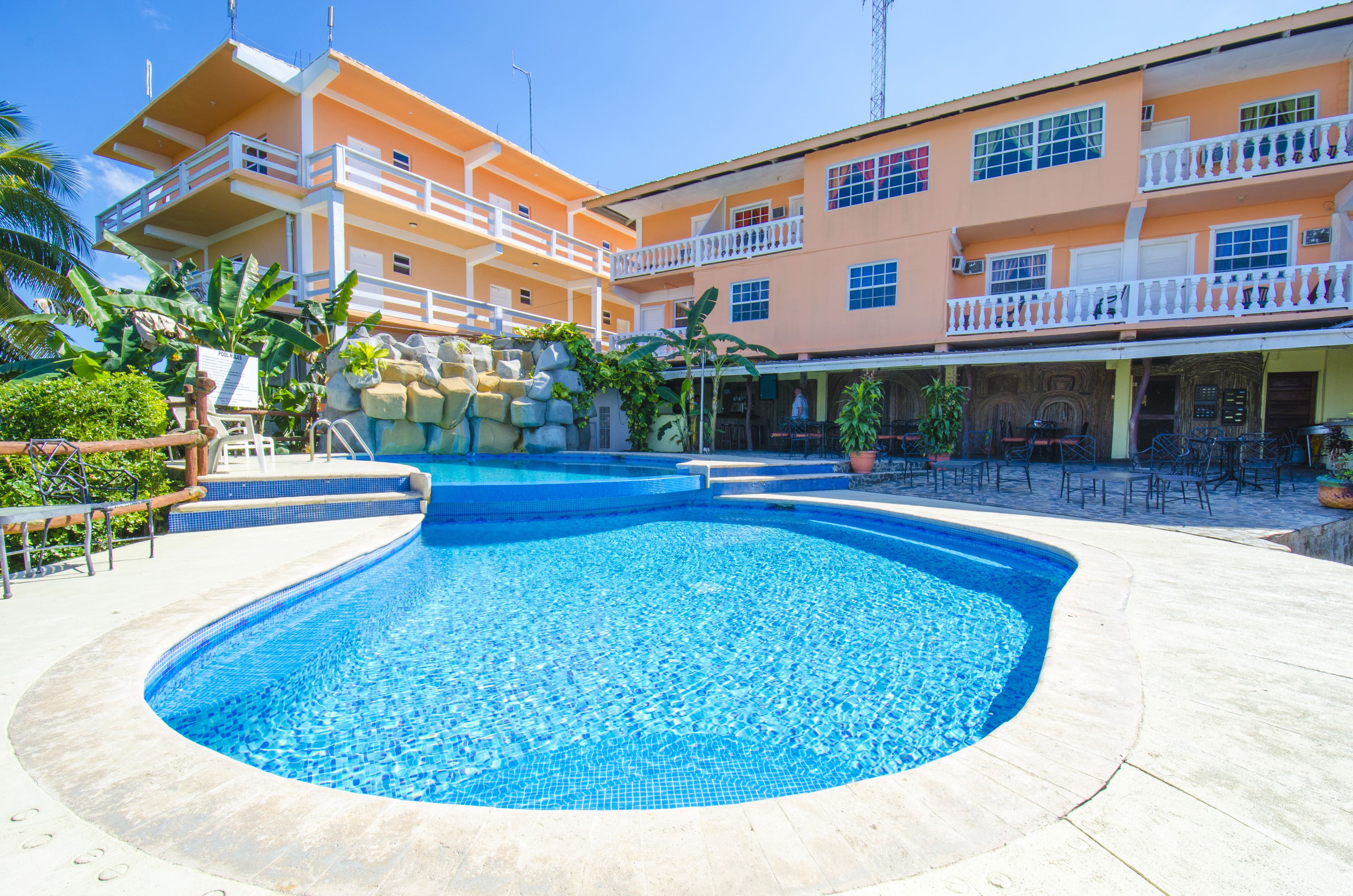 A swimming pool with a curved edge, surrounded by a concrete deck.