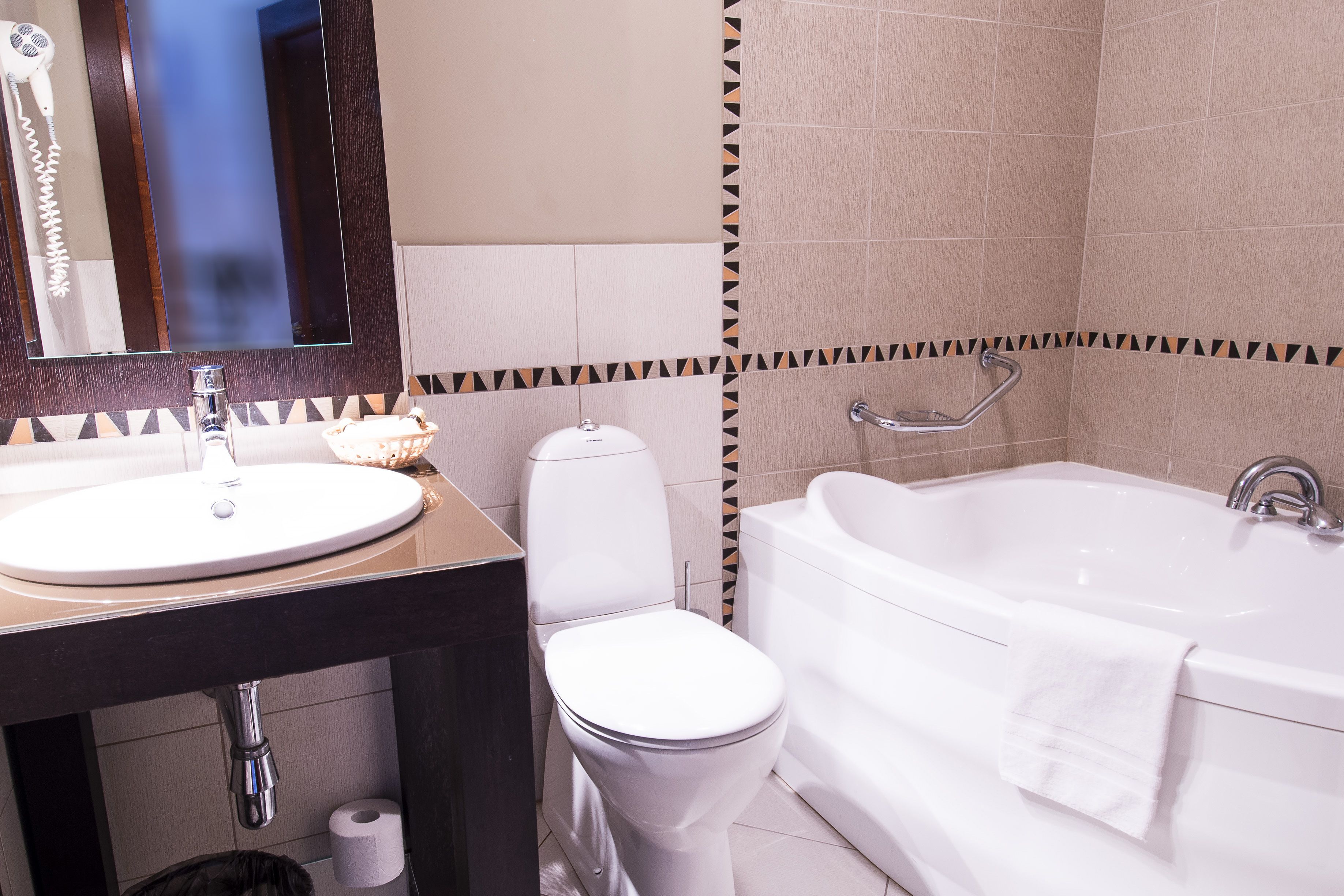 A bathroom with a sink, toilet, and bathtub.