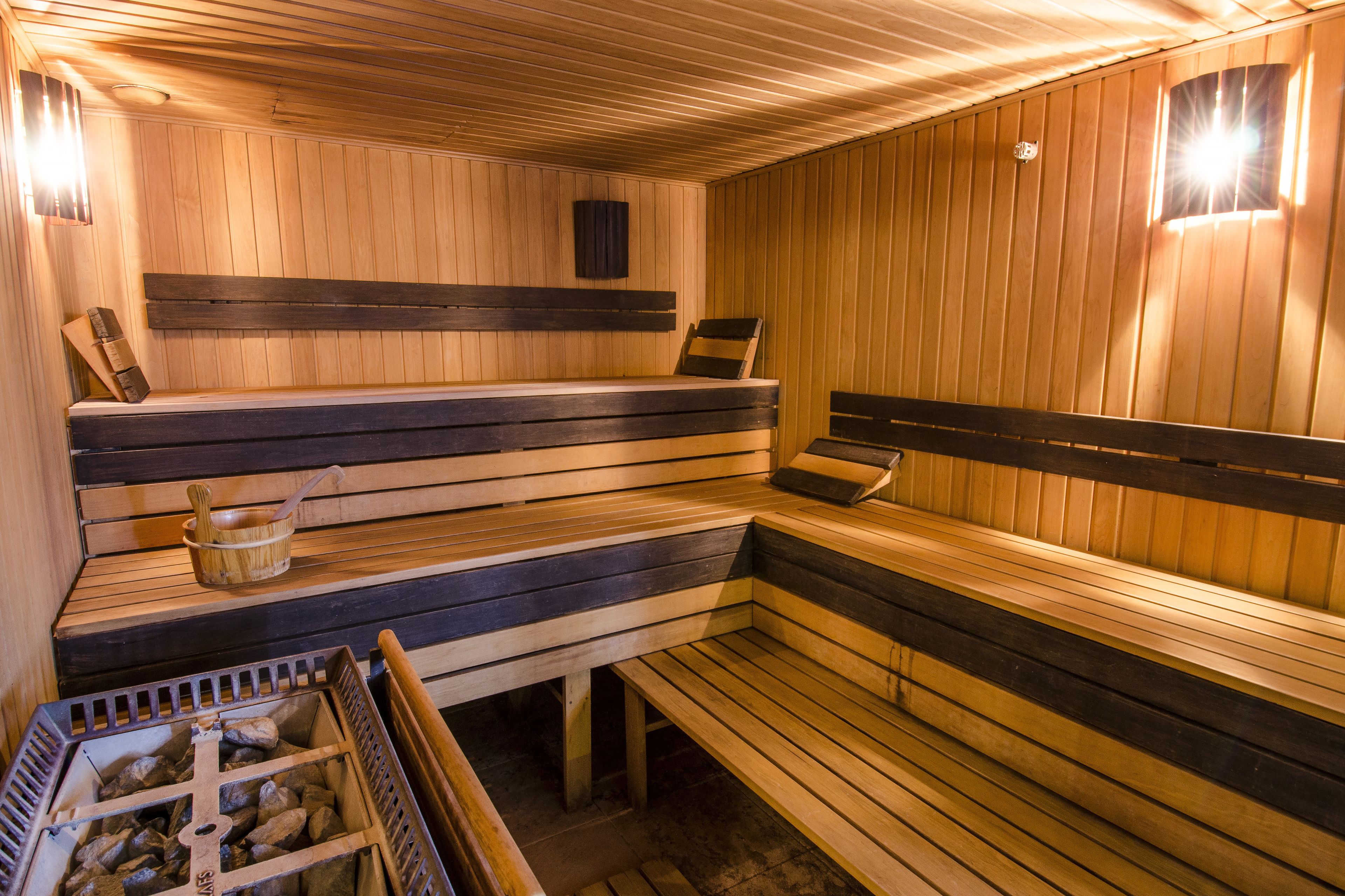 A sauna with wooden benches and a wooden floor.