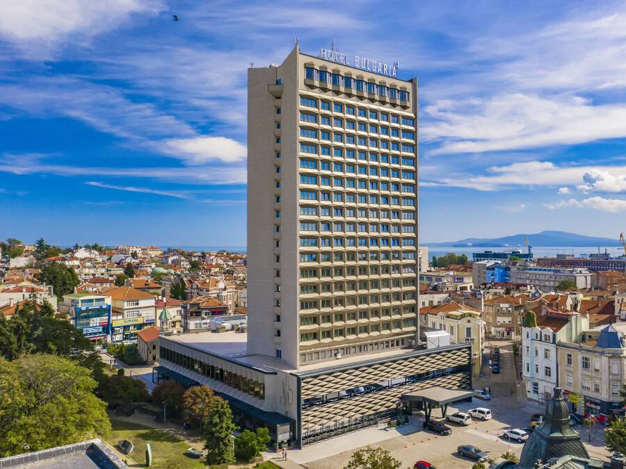 A tall hotel building with a modern facade and a sign reading "Hotel Bulgaria".