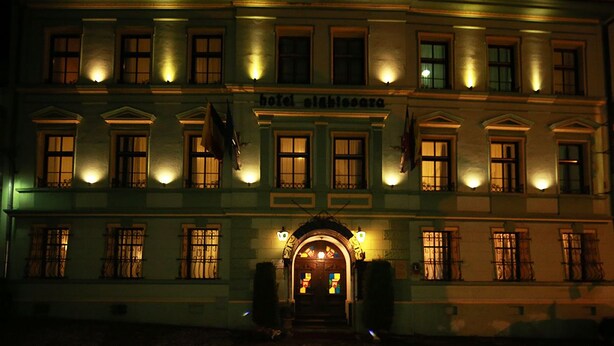 A historic building with a central entrance, multiple windows, and a sign indicating it is a hotel. - Hotel Sighisoara (Sighisoara)