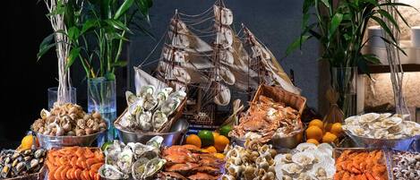 A seafood buffet with various shellfish and seafood displayed on ice.