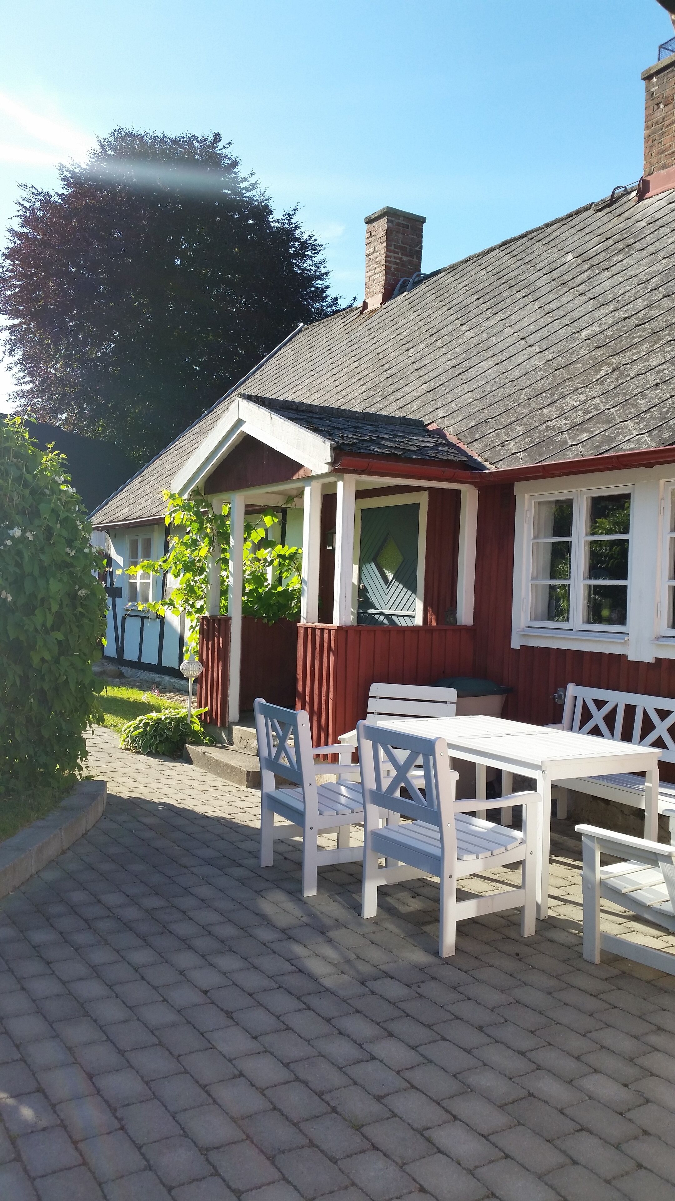A traditional building with a tiled roof and a small porch area.