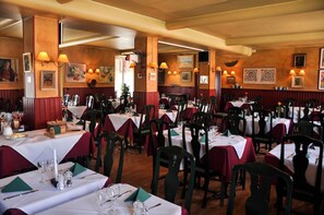 Enjoy a traditional dining experience in our elegant dining area, featuring tables set with crisp linens and fine silverware.