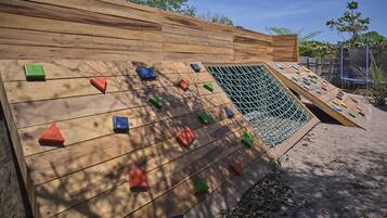 Challenge your limits on this outdoor climbing wall with a variety of holds.