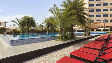 Outdoor pool, open 7:00 AM to 7:00 PM, pool loungers