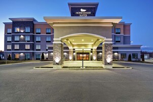 A hotel entrance with a sign reading "Homewood Suites."
