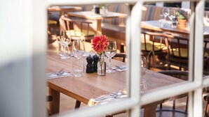 A dining area with wooden tables and chairs, arranged for service. - The Plume of Feathers (Newquay)