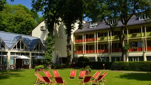 Un hôtel doté d’une cour intérieure, de places assises en plein air et d’un bâtiment agrémenté de nombreux balcons.