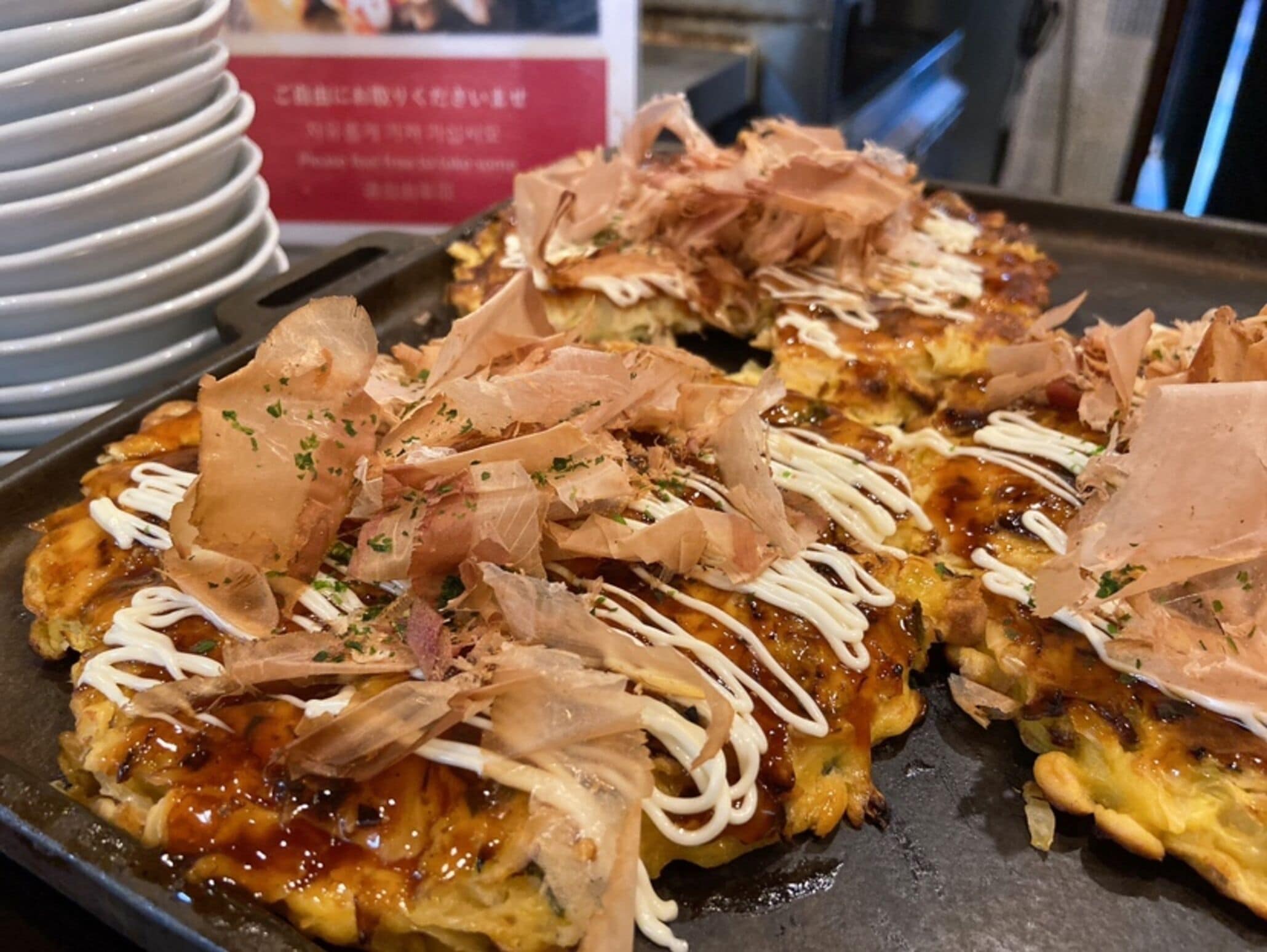 A tray of food with toppings, possibly a Japanese dish, on a table.
