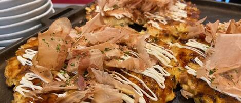 A tray of food with toppings, possibly a Japanese dish, on a table.