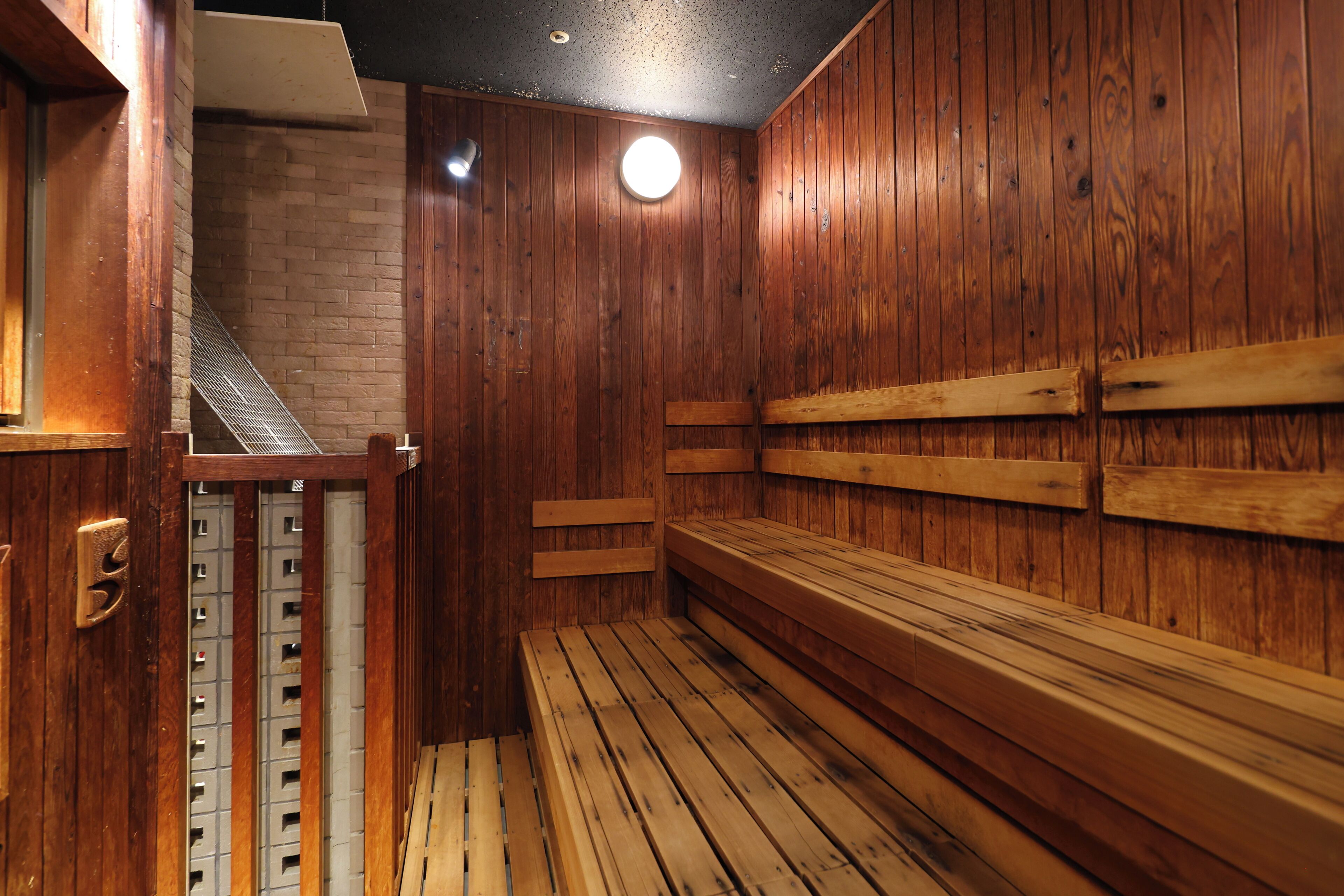 A sauna with wooden benches and a tiled floor.
