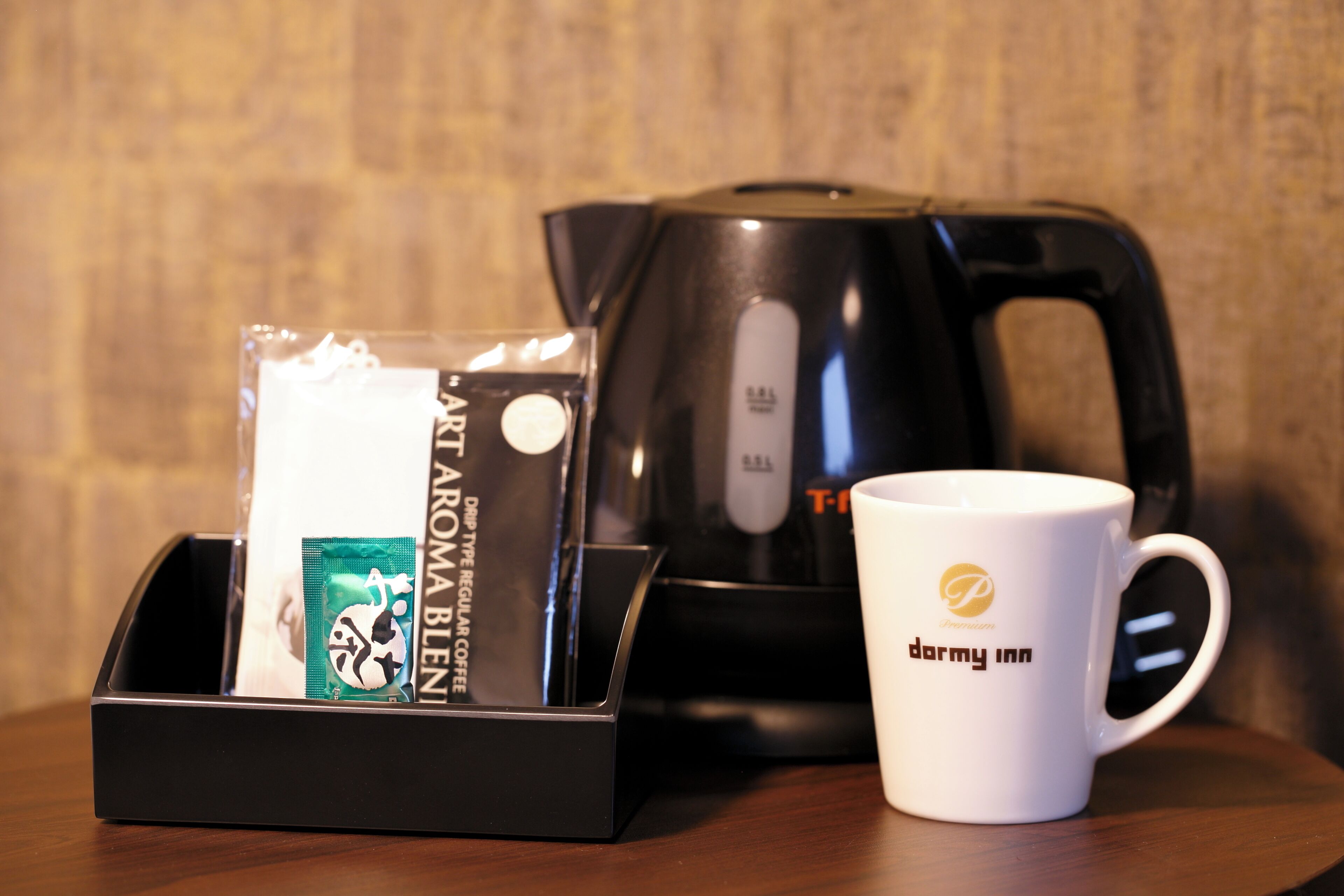 A coffee maker, a mug, and a coffee pod holder on a wooden table.