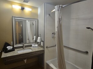 A bathroom with a sink, mirror, and shower. - Holiday Inn Express & Suites Perry-National Fairground Area, an IHG Hotel (Perry)