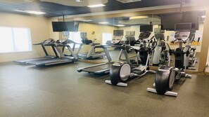 A gym with treadmills, elliptical machines, and weight equipment. - Holiday Inn Express & Suites Perry-National Fairground Area, an IHG Hotel (Perry)