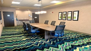 A conference room with a long table, six chairs, and a patterned carpet. - Holiday Inn Express & Suites Perry-National Fairground Area, an IHG Hotel (Perry)