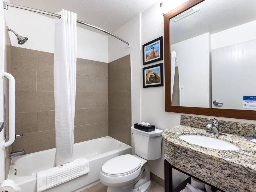 A bathroom with a shower, toilet, and sink.