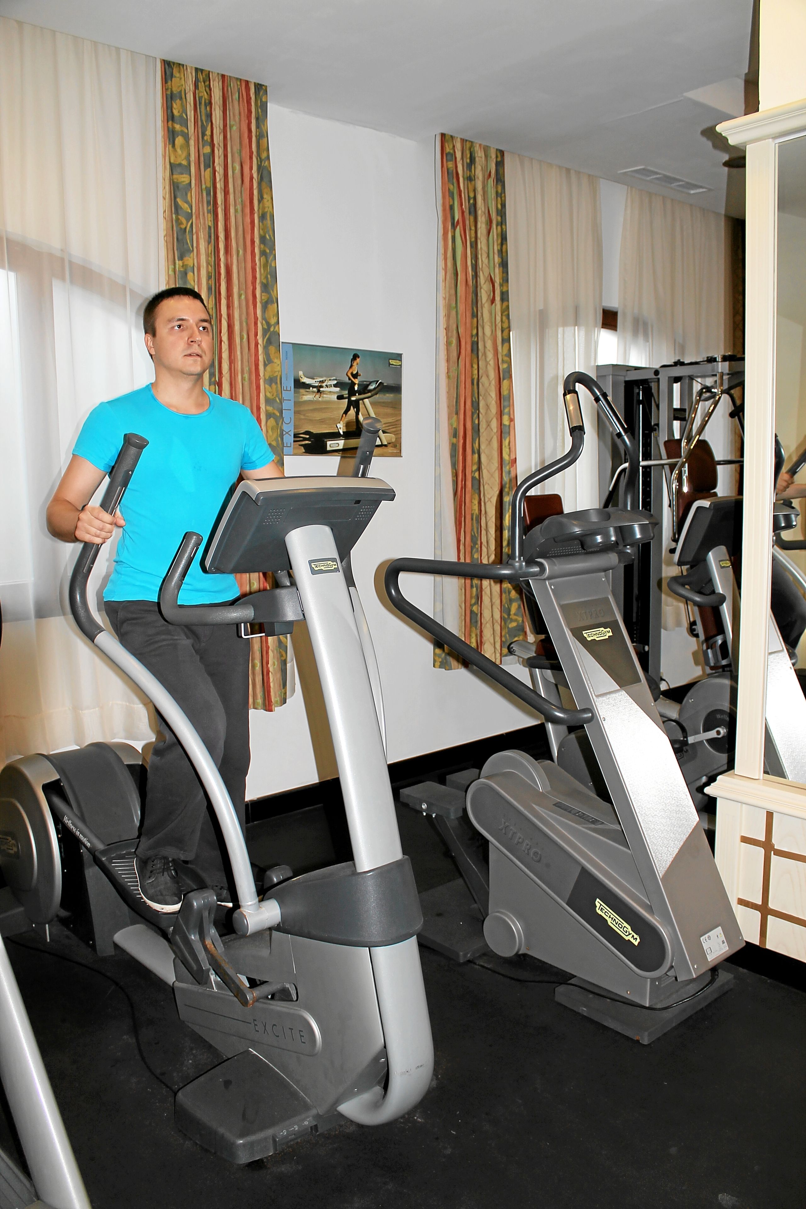 A gym with stationary bikes and a treadmill.
