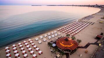 Am Strand, Liegestühle, Sonnenschirme, Strandtücher