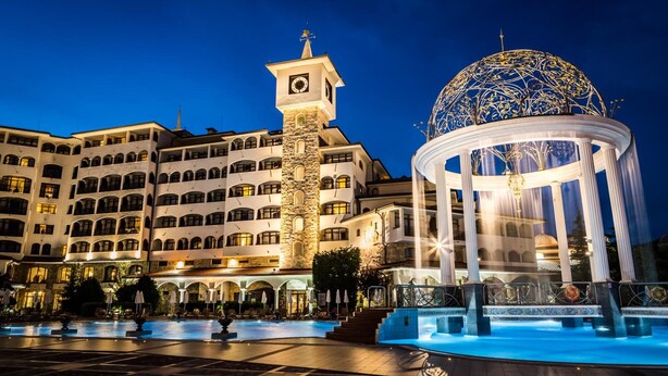 A hotel with a central courtyard, a fountain, and a large dome structure. - Helena VIP Villas and Suites (Sunny Beach)