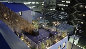A multi-level parking structure with several cars parked. - Piece Hostel Kyoto (Kyoto)