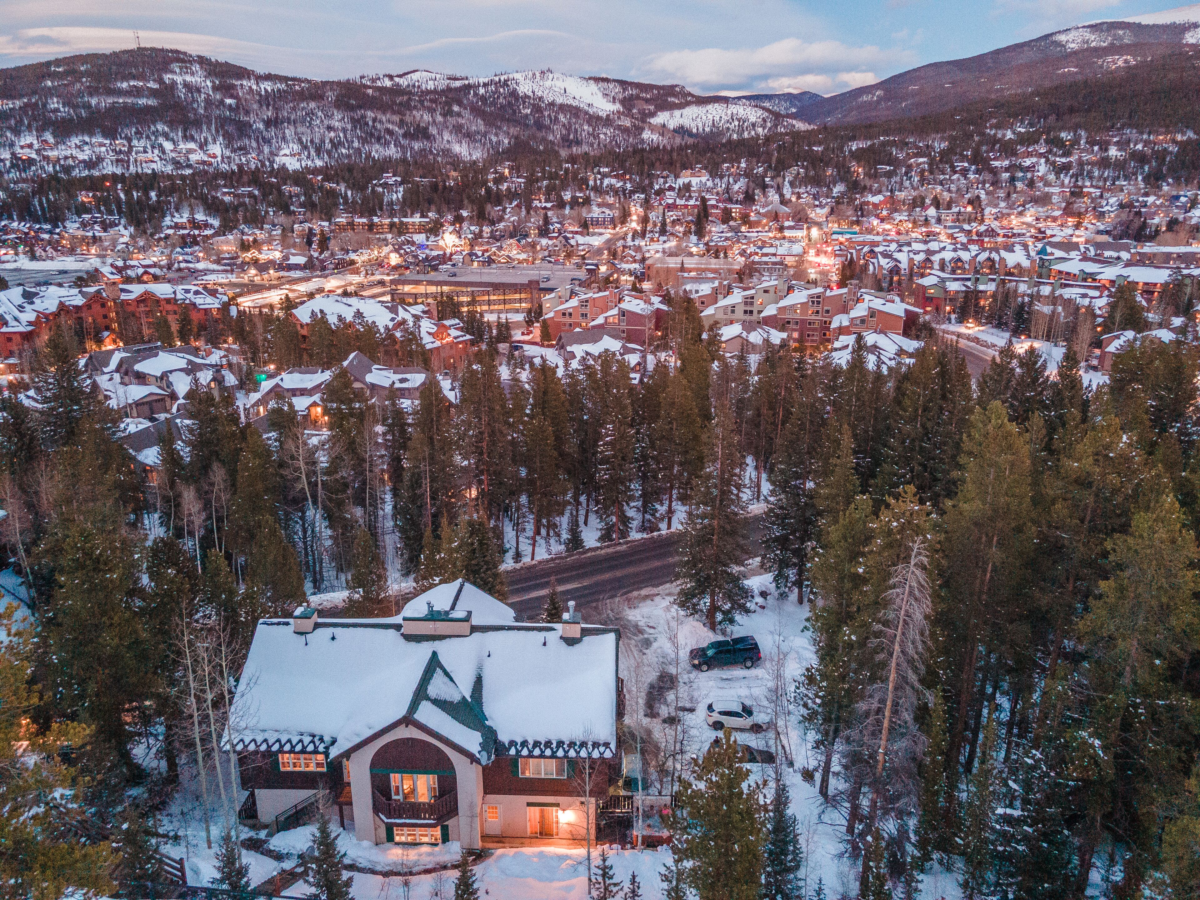 A snow-covered town with a prominent lodge featuring a steep roof and a balcony.