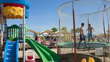 Children can play safely in the enclosed playground with slides and climbing equipment.