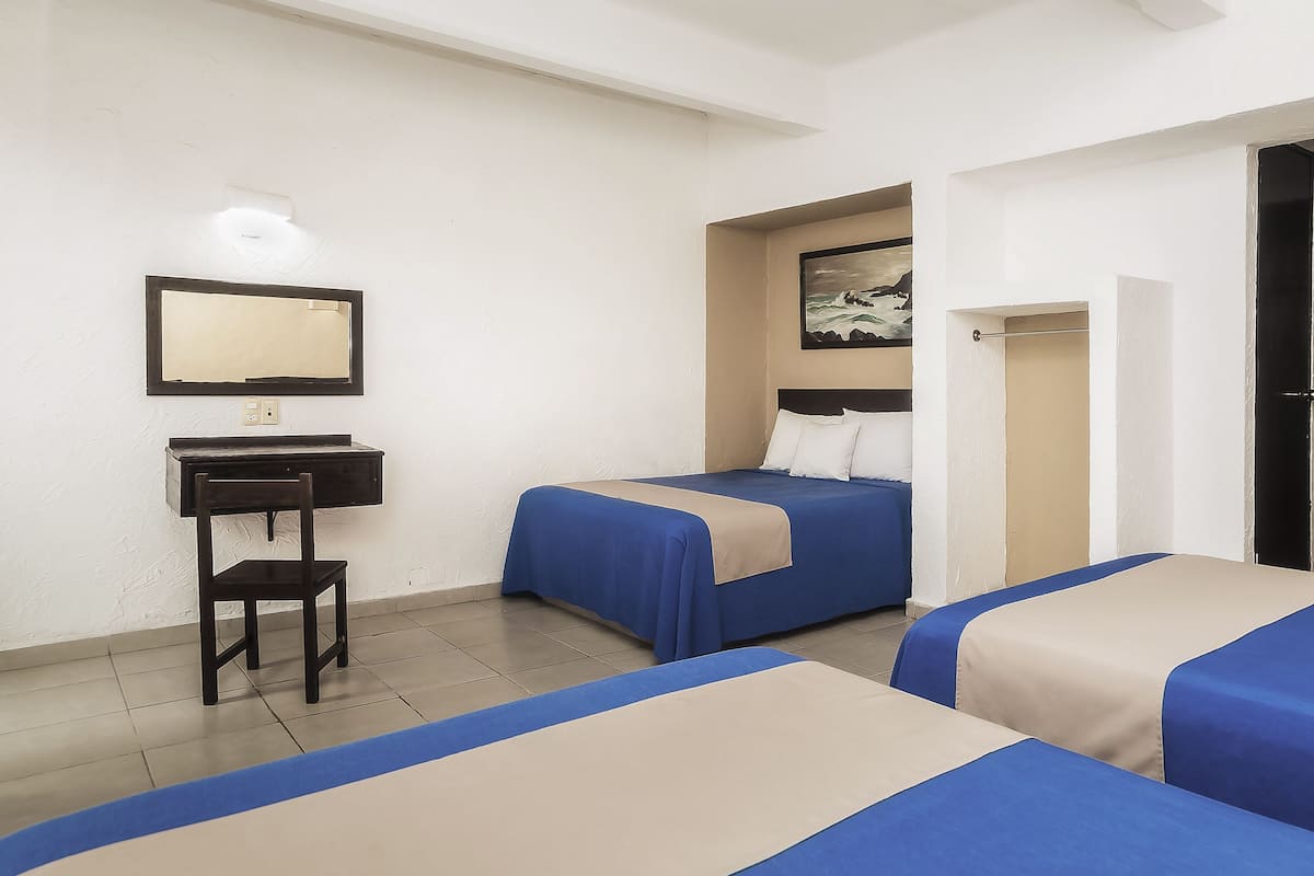 A hotel room with two beds, a desk, a chair, a mirror, and a painting on the wall.