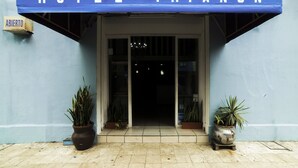 The entrance to Hotel Trianon with a blue awning and a sign indicating it is open. - Hotel Trianon (Veracruz)