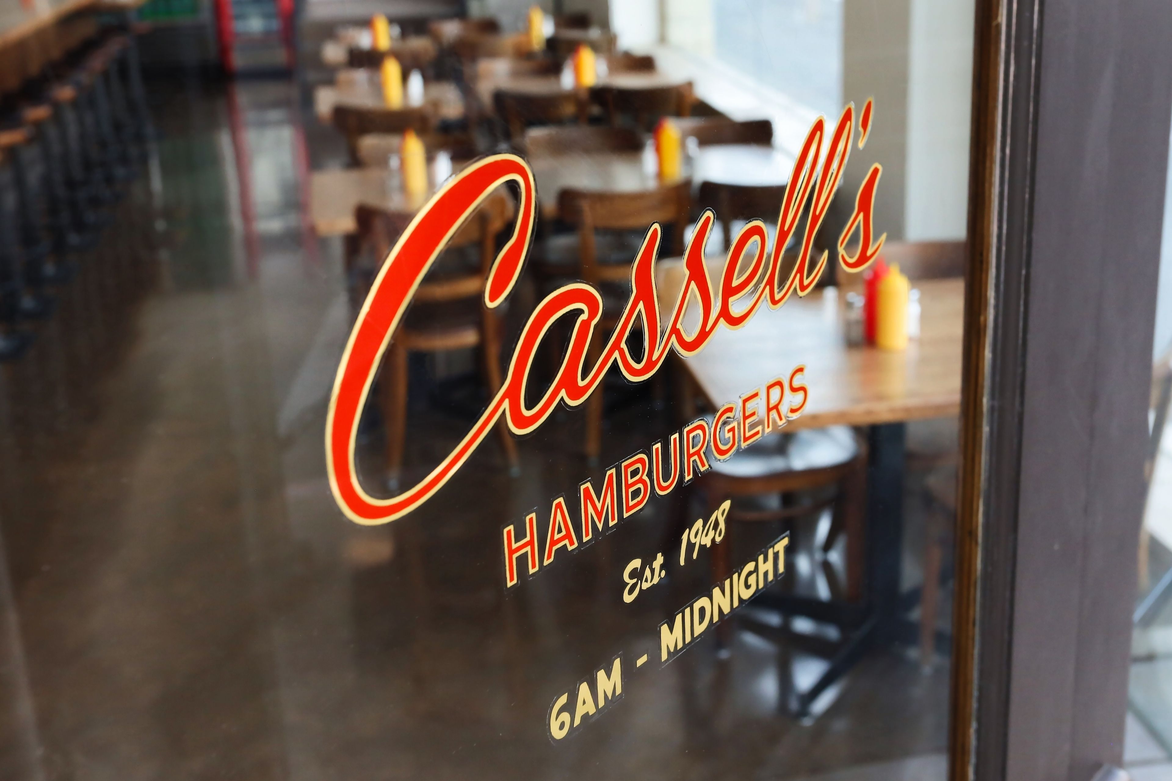 A restaurant window with the name "Casselli's Hamburgers" and the establishment year "Est. 1948".