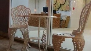 A reception area with a glass partition, two ornate chairs, a small table, and a decorative wall. - Nantra Chaweng Beach, Samui (Koh Samui)