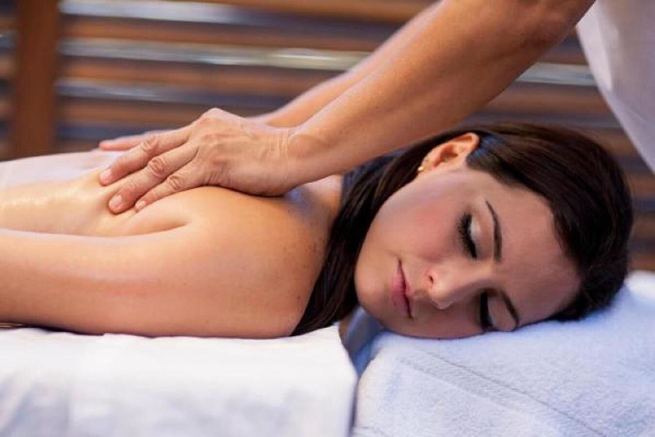 A person receiving a massage on a massage table.