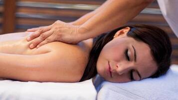 A person receiving a massage on a massage table.