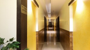 Pasillo de hotel con un cartel que indica el primer piso y los números de habitación de 209 a 218.